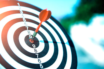 Close up a red color arrow in the center of Bullseye or bull's-eye for business targeting and good...