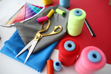 Fashion Designing Tailor Craftsmanship Concept. Fabric, Color Palette and Sewing Tools on Table....