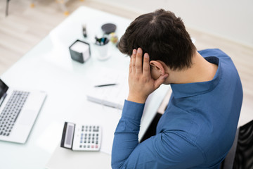 Thoughtful Businessman Doing Calculations