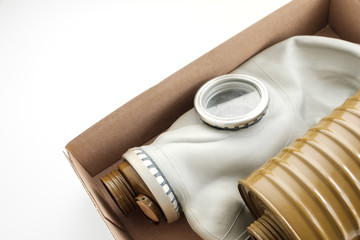 on a white background an open parcel in which the gas mask