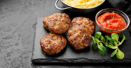 Juicy delicious turkey meat cutlets served with mashed potato and sauce.