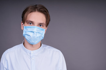 Young handsome guy in a medical mask.