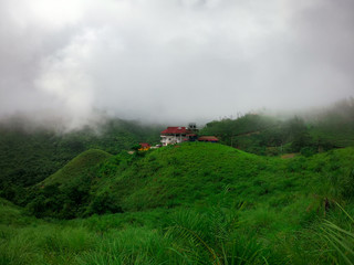 Fototapeta na wymiar House in a Cloudy Mountains
