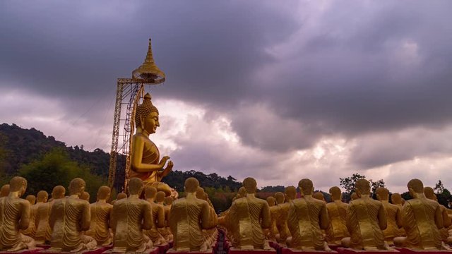 .a golden big Buddha statue sitting inside small buddha statues .the golden big Buddha statue among a lot of small Buddha statues in Makha Bucha Buddhist memorial park at Nakornnayok Thailand..