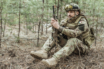 Handsome man in italian military uniform camouflage coloring Digital Vegetato