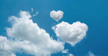 Fototapeta na wymiar heart shaped cloud on bright blue sky white clouds