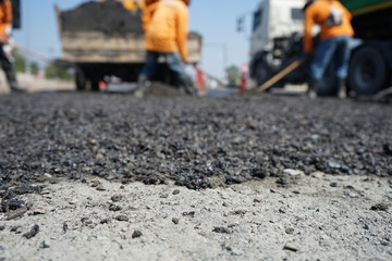Blur image, repairing pavement mainly by manual labor