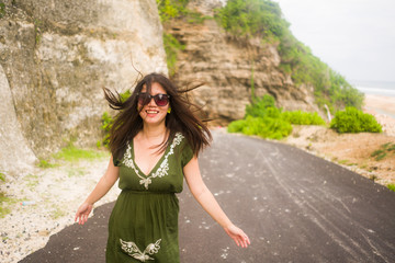  young beautiful and happy Asian Korean woman smiling cheerful looking playful and relaxed wearing chic sunglasses looking at the camera excited and joyful