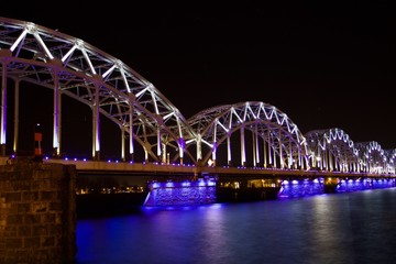 Railway  bridge illuminated at night in Riga, Latvia 