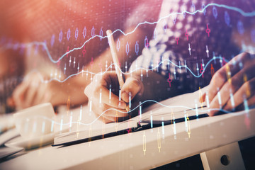 Multi exposure of two men planing investment with stock market forex chart.