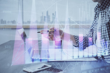 Double exposure of stock market chart with man working on computer on background. Concept of...