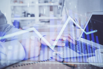 Multi exposure of stock market chart with man working on computer on background. Concept of...