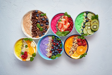 Obraz na płótnie Canvas Various healthy fresh smoothies or yogurts in bowls. With strawberries, kiwi, chia, blackberries