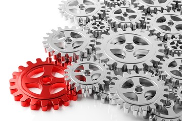 Heap of mechanical gear cogwheels wiith one red key cog over white background - leadership, industry, teamwork, solution or cooperation concept