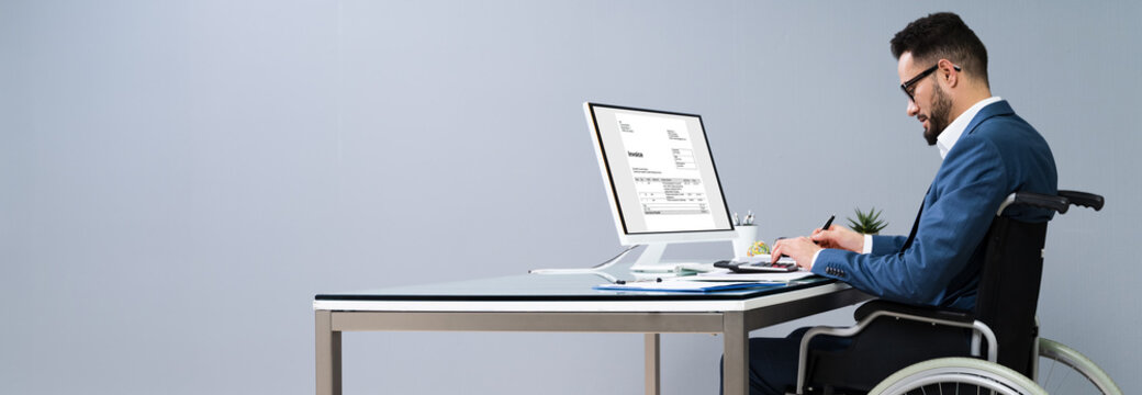 Businessman Working In Office Sitting On Wheelchair