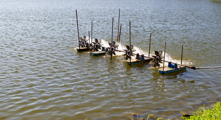 Fototapeta premium Waste water treatment system. Water turbine for oxygen filling to water. Aerator machine in the pond