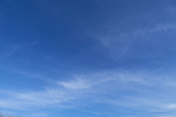 Obraz premium Bright beautiful blue sky with soft clouds for background or texture