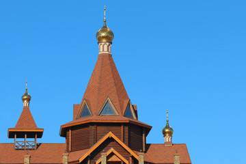 Fototapeta na wymiar Church and cross against the blue sky