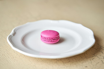 French macaroon dessert on white plate. Modern european French cuisine.