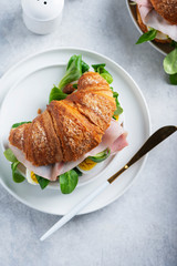 Fresh croissant with green salad