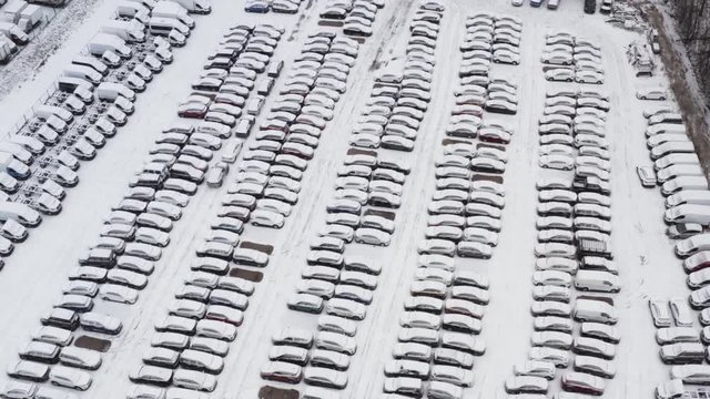Aerial view Parking at the factory. cars are covered in snow are on the street