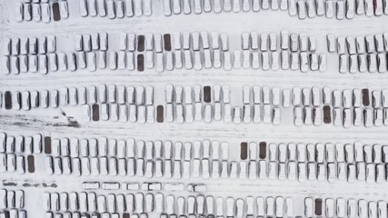 Aerial top view cars covered with snow are in the Parking lot.