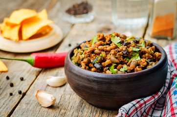 vegetarian chili with cilantro on a dark wood background