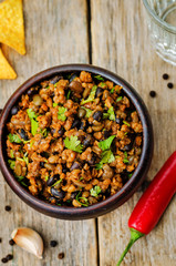 vegetarian chili with cilantro on a dark wood background