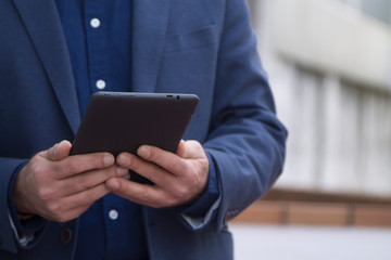man in suit using a tablet
