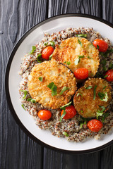 baked eggplant with tomatoes with a side dish of quinoa closeup on a plate. Vertical top view
