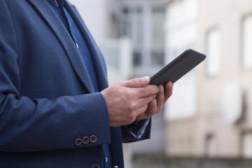 man in suit using a tablet