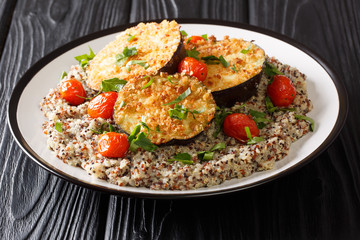 Vegan food baked eggplant served with boiled quinoa close-up on a plate. horizontal