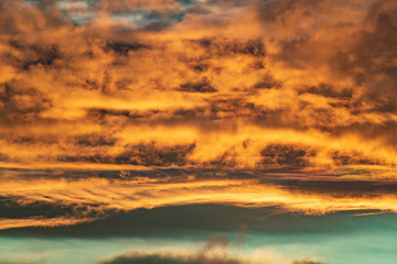 Aerial view of dramatic clouds lit from below at sunset