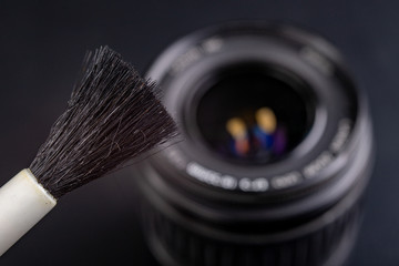 Cleaning the photographic lens. Removing dust and dirt from photo accessories.