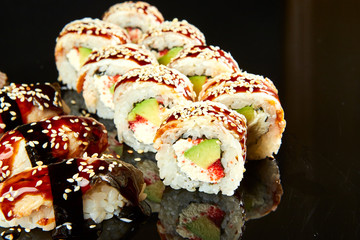 Various kinds of sushi roll set served on black stone. Japanese food