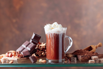 Hot chocolate with cream, cinnamon, chocolate pieces and various spices.