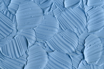 Obraz premium Light blue bentonite facial clay (mask, face cream, body wrap) texture close up, selective focus. Abstract background with brush strokes.