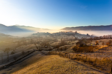 Beautiful misty rural landscape at sunrise in Romania