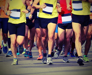 Fototapeta na wymiar legs of many runners during a race