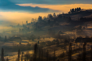 Beautiful misty rural landscape at sunrise in Romania