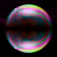 A soap bubble shimmering with all the colors of the spectrum