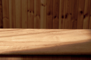 image of a wooden table in front of a blurred wooden background, wooden mock up 