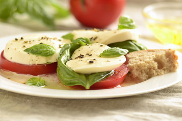 Fototapeta na wymiar Caprese salad of tomato, mozzarella, basil. Italian food.