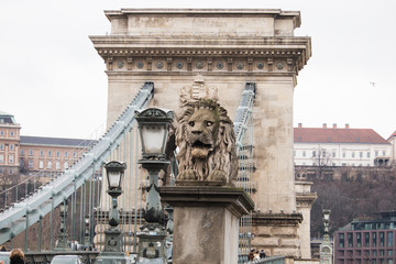 Stone lion statue on the beginning of old bridge.