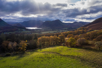 Beautiful aerial drone Autumn Fall landscape image of view from Low Fell in Lake District looking towards Crummock Water and Mellbreak and Grasmoor peaks