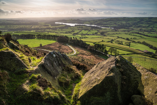 Epic Peak District Winter landscape of view from top of Hen Cloud over countryside and towards Tittesworth Reservoir