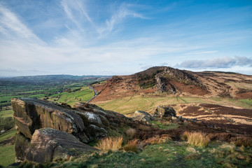 Epic Peak District Winter landscape of Ramsaw Rocks viewed from Hen Cloud with beautiful sunset sky