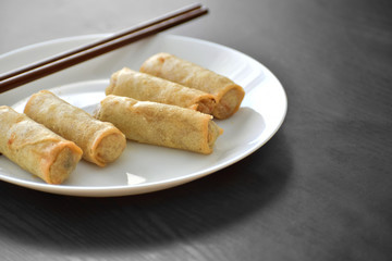 Spring rolls on a white plate. 