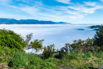 Fototapeta na wymiar Above the clouds blue sky mountains New Zealand