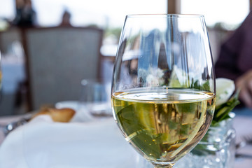 Wine white glass closeup. blur restaurant background